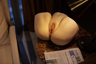 Realistic torso sculpture highlighting big butt sex torso popularity on a stylish table