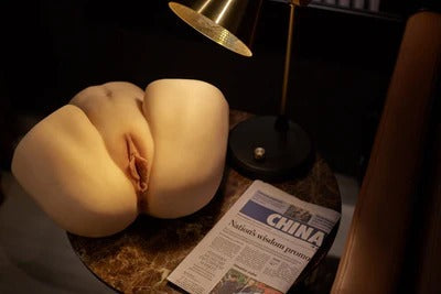 Tips for maximizing pleasure with male masturbator displayed on a table with a lamp and newspaper